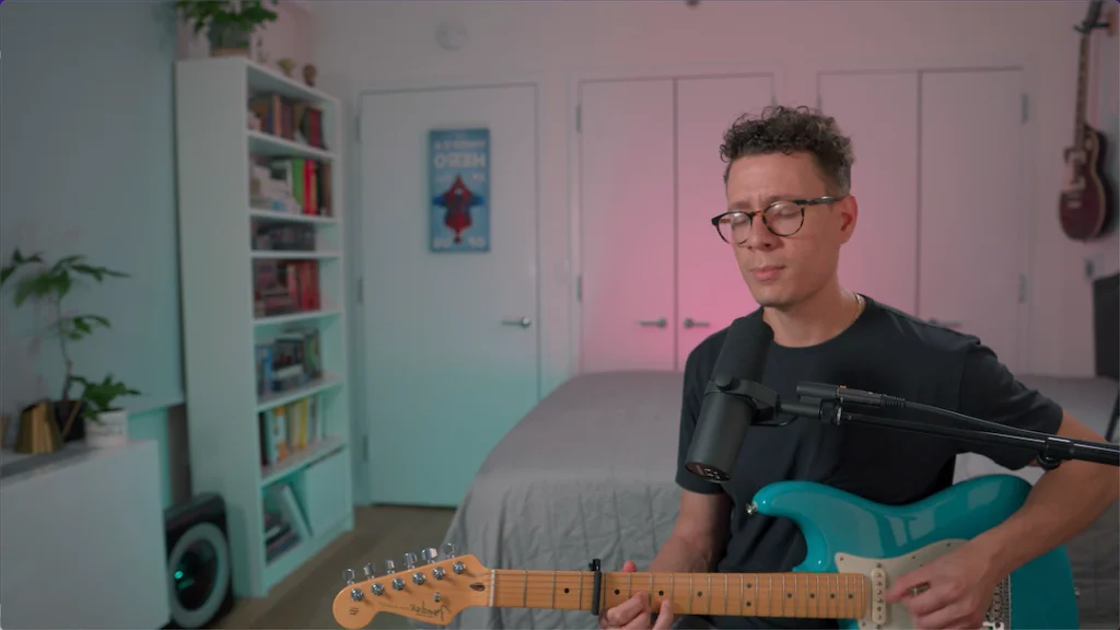 Enrique playing guitar during a home worship session